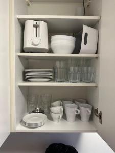 a cabinet filled with dishes and cups and plates at Gemütliche Wohnung nähe Alsfeld - Parkplatz in Alsfeld