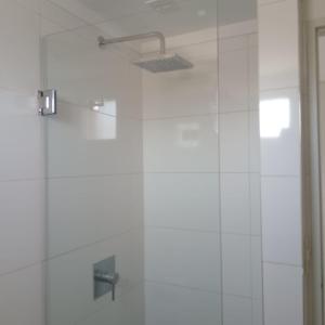a bathroom with a shower with a glass door at Mendoza 1638 Aparments in Rosario