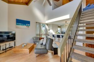 a living room with a staircase and a couch at Top-Floor Kailua Bay Resort Condo with Ocean Views! in Kailua-Kona