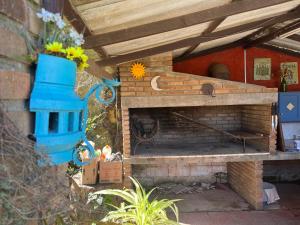 a brick fireplace with a bird house and a vase of flowers at Paz y armonía en Chuy in Chuy