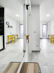 a hallway with a door in a room with tables at OOTA Soko Ha in Kragujevac