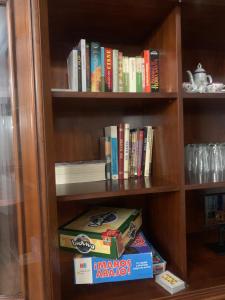 a book shelf with many books on it at El Encanto de Abadía in Abadía