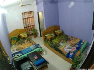 2 Betten in einem kleinen Zimmer mit in der Unterkunft Hotel Rongdhanu Residential in Dhaka