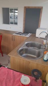 a kitchen with a sink in a wooden counter top at Semi Amoblado Manta Mall del Pacifico; Playa Murciélago in Manta