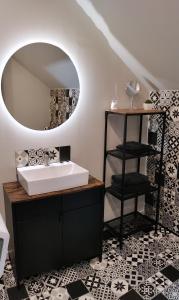 a bathroom with a sink and a mirror at La folie 20 Spa in Hon-Hergies +22 photos