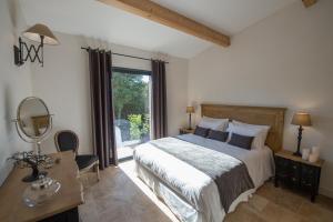 a bedroom with a bed and a desk with a mirror at Villa Madra in Bonifacio +136 photos