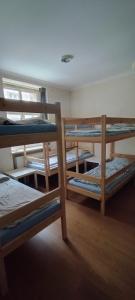 a room with three bunk beds and a window at Hostel ALEX&TSA in Krakow