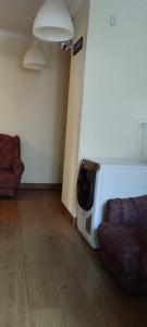a living room with a couch and a tv at Hostel ALEX&TSA in Krakow