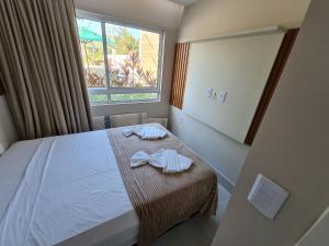 a bedroom with a bed with two towels on it at Fuja para o Paraíso em Porto de Galinhas! in Porto De Galinhas +19 photos