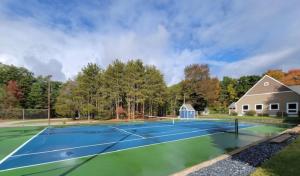 a tennis court in front of a house at Indoor Pool Near Grand Haven & Lake Michigan Beach in Spring Lake