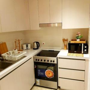 a kitchen with a stove and a microwave at B8 Studio close to Formula 1 with Ferrari world view in Abu Dhabi