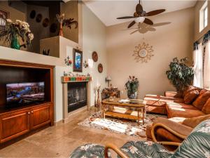 a living room with a couch and a tv at Beautiful El Dorado Ranch Vacation Rental Condo in San Felipe