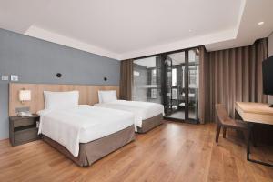 Rúm í herbergi á Four Points by Sheraton Yilan Jiaoxi