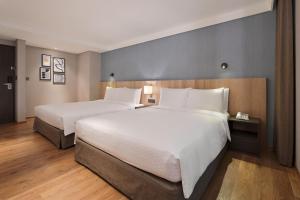 Rúm í herbergi á Four Points by Sheraton Yilan Jiaoxi