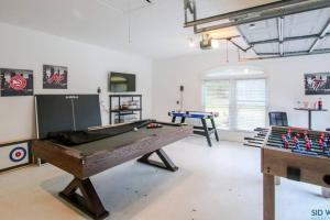 a room with a ping pong table and two games at Savannah 5BR Pool, Jacuzzi, Firepit, Sports, Games in Savannah
