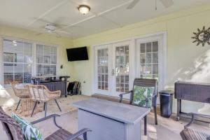 a living room with chairs and a table and a tv at Savannah 5BR Pool, Jacuzzi, Firepit, Sports, Games in Savannah