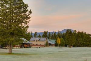 a large building with a tree in a field at Quiet Island Park Family Home Near Yellowstone! in Rea