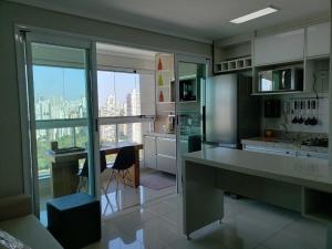 a large kitchen with a view of a city at Nature - Easy Life - Vaca Brava in Goiânia