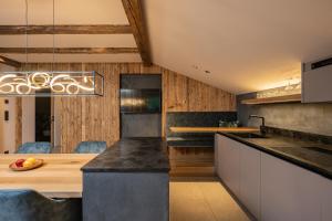 a kitchen with a large wooden table and chairs at myLoisl Apartments in Lutago