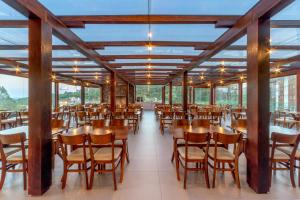 a dining room with wooden tables and chairs at Laghetto Resort Golden Oficial in Gramado +59 photos