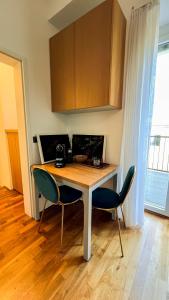 een keuken met een houten tafel en 2 stoelen bij Triangle City Center Apartment in Wenen