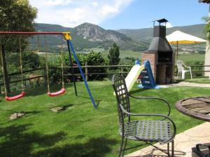 a yard with a playground with a swing at Casa Rural Juanbarterena in Ulzurrun