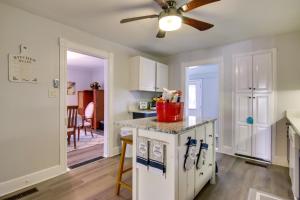 a kitchen with white cabinets and a ceiling fan at Charming Salisbury Getaway with Grill and Fire Pit! in Salisbury