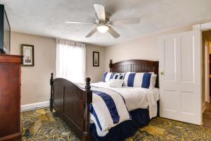 a bedroom with a bed with a ceiling fan at Charming Salisbury Getaway with Grill and Fire Pit! in Salisbury