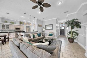 a large living room with a couch and a kitchen at Destiny Casa - PRIVATE HEATED POOL and 6 SEATER GOLF CART in Destin