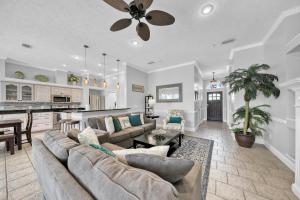 a large living room with a couch and a kitchen at Destiny Casa - PRIVATE HEATED POOL and RESORT AMENITIES in Destin