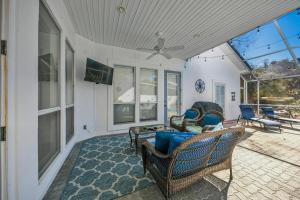 a living room with chairs and a table at Destiny Casa - PRIVATE HEATED POOL and 6 SEATER GOLF CART in Destin