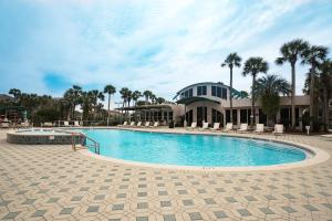 a large swimming pool in front of a building at Destiny Casa - PRIVATE HEATED POOL and 6 SEATER GOLF CART in Destin