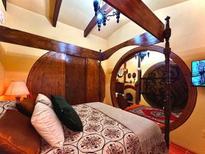 a bedroom with a bed with a large wooden headboard at Toca do Hobbit - Vila Mágica in Bueno Brandão