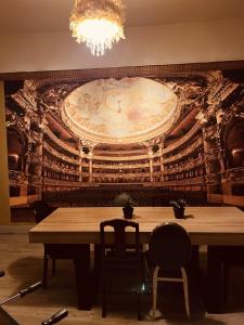 a dining room with a table and a large wall at LA MARIEFACTURE - Comme à l'Opéra in Neuf-Brisach