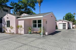 a pink house with plants in front of it at Lovely North Hollywood House Near Universal in North Hollywood