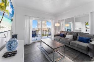 a living room with a couch and a coffee table at Sandpiper Oceanfront 5F in Jacksonville Beach