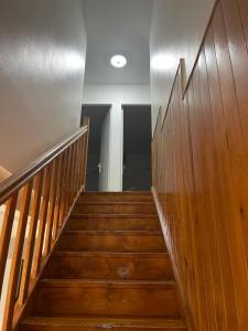 a wooden staircase in a building with a stair case at MAISON CHIC ET CALME in Étampes