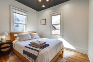 a bedroom with a bed and two windows at Pet-Friendly Saint Paul Rental Near Downtown! in Saint Paul
