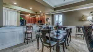 a kitchen with a table and chairs and a bar at Harbor Landing 701B - 3BR Luxury condo with Gulf and Destin Harbor Views in Destin