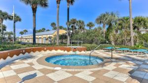 a small pool in a courtyard with palm trees at Harbor Landing 701B - 3BR Luxury condo with Gulf and Destin Harbor Views in Destin