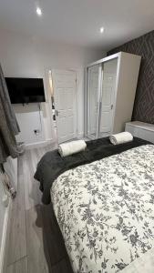 a bedroom with two beds and a flat screen tv at 179 church Road in London