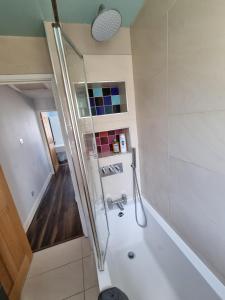 a bathroom with a shower and a bath tub at Solo Stay London Zone 1 in London
