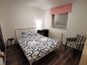 a small bedroom with a bed and a chair at Solo Stay London Zone 1 in London