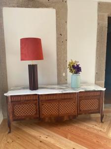 a table with a lamp on top of it at Porta Nobre - Exclusive Living Hotel in Porto