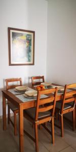 a dining room table with four chairs and a painting at Sunhouse in Playa Honda +19 photos