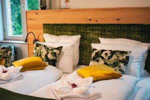 a bedroom with two beds with yellow and white pillows at Gasthof Schloss Hubertus in Erfurt +9 photos
