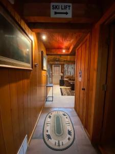 a hallway of a house with a rug on the floor at U.P Norse A-frame close to Powderhorn Ski Resort in Ironwood