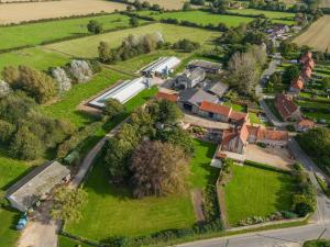 an aerial view of a village with houses and trees at The Old Laundry in Great Snoring