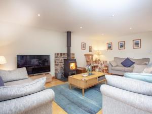 a living room with two couches and a fireplace at Tembridge House - Uk37698 in Witheridge