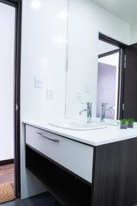 a bathroom with a sink and a mirror at Sky Suites - Fantastic Apt in the heart of La Paz in La Paz